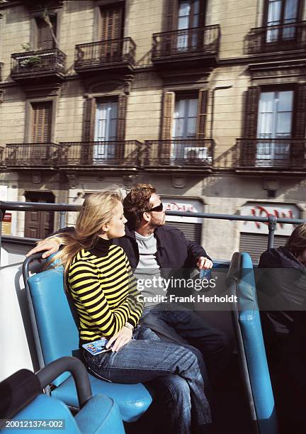 spain, barcelona, couple in open top bus - open top bus stock pictures, royalty-free photos & images