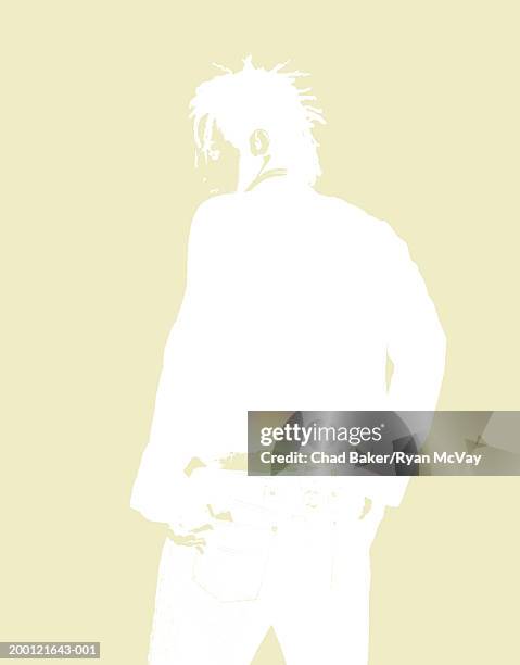 young man standing with hands in his pockets (digital enhancement) - yellow jacket stock illustrations