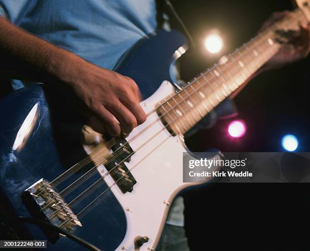 mature man playing electric guitar, mid section - blues in the night stock-fotos und bilder