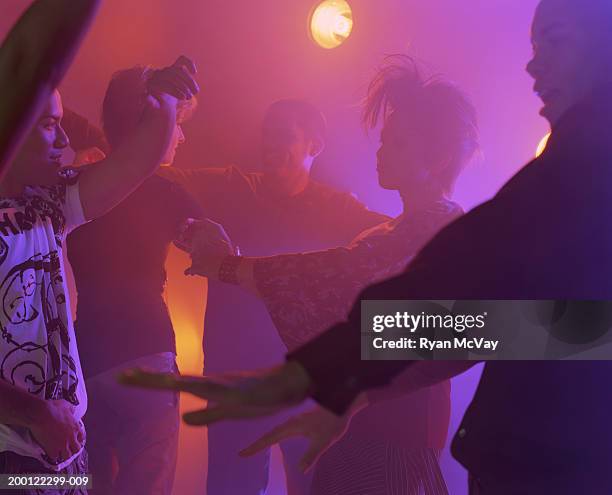 young men and women dancing at nightclub - haze nightclub stock pictures, royalty-free photos & images