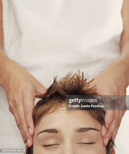 young woman receiving head massage, close-up - head massage fotografías e imágenes de stock