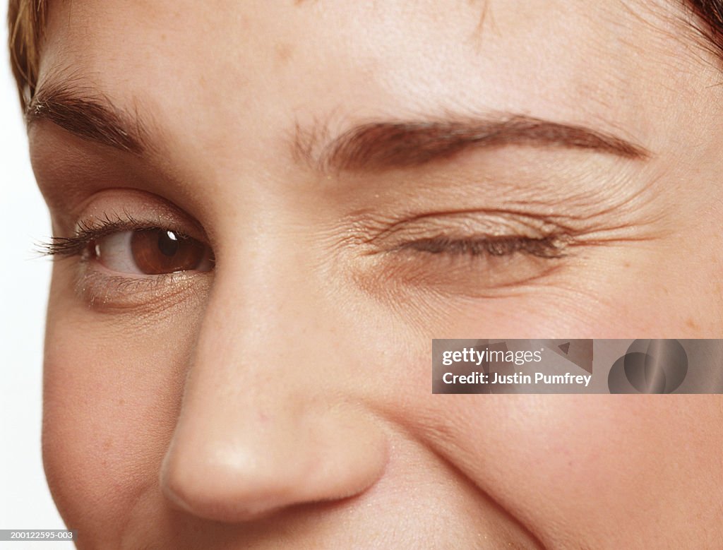 Young woman winking, portrait, close-up