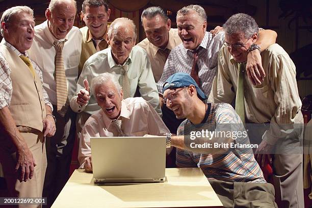 group of men laughing at laptop - looking backwards stock pictures, royalty-free photos & images