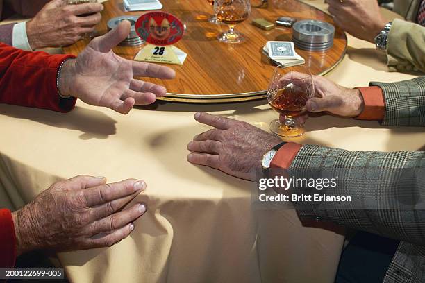 group of men at table in restaurant, close-up - senior men playing cards stock pictures, royalty-free photos & images