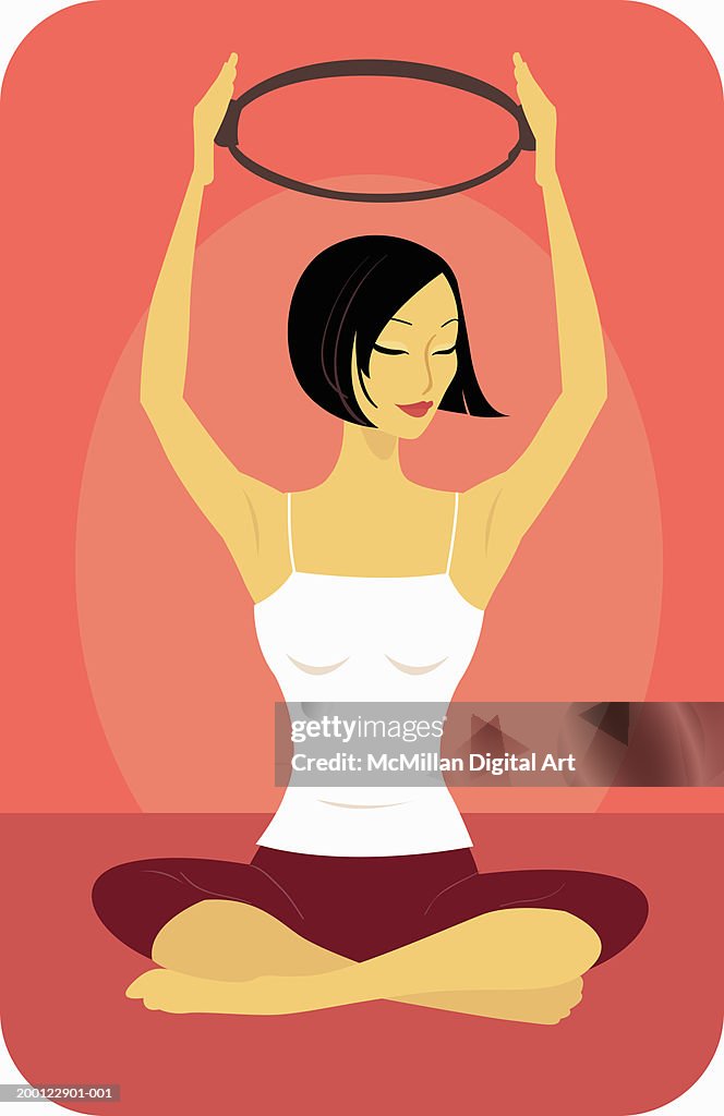 Woman practicing Pilates, arms raised