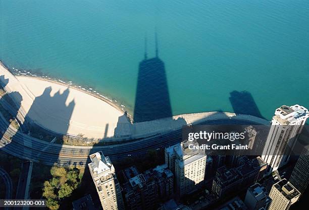 usa, illinois, chicago, shadow of john hancock tower on city and lake - hancock building chicago stock pictures, royalty-free photos & images