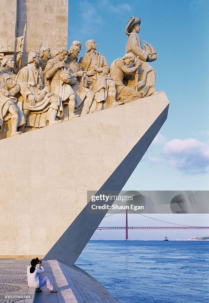 Portugal, Lisbon, woman photographing Monument to the Discoveries