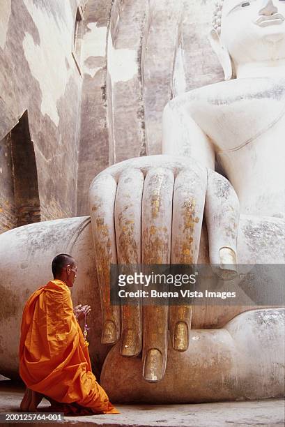 buddhist monk praying at wat si chum temple, rear view - sukhothai stockfoto's en -beelden