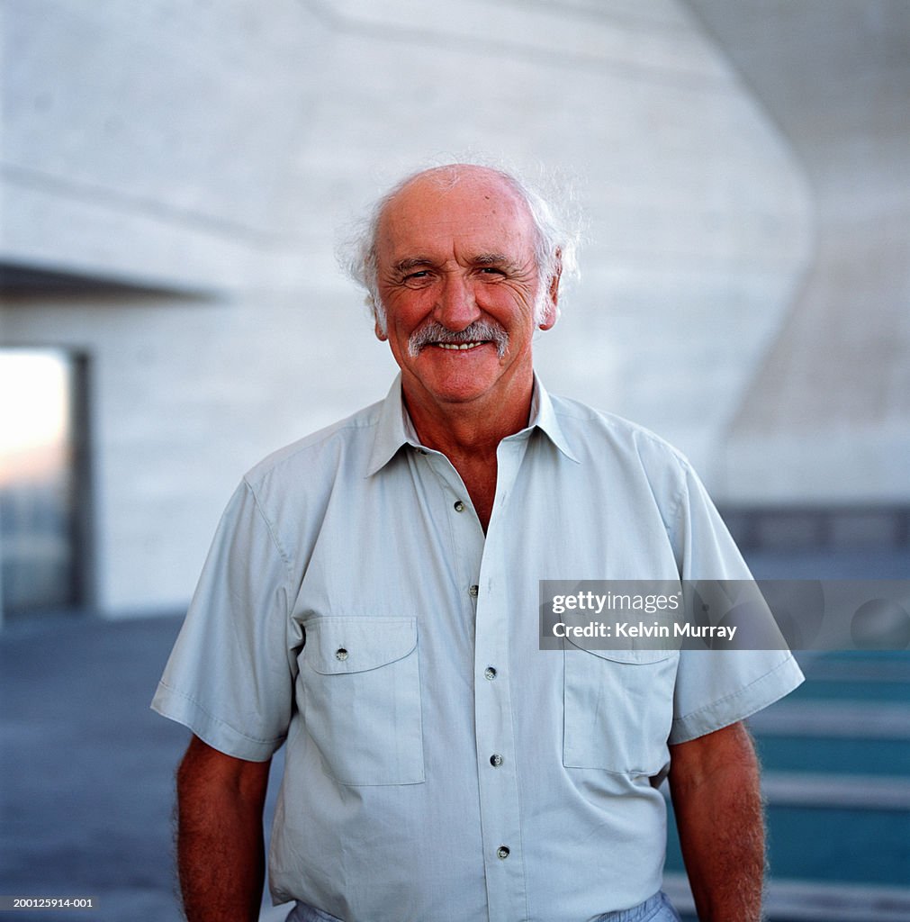 Mature man smiling outdoors, portrait