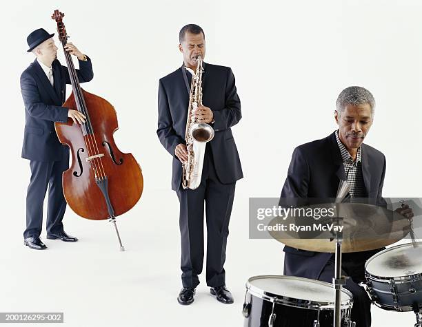 jazz trio playing saxophone, bass, and drums - jazz imagens e fotografias de stock