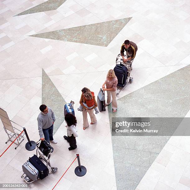 people queuing with luggage in airport, elevated view - inconvenience stock pictures, royalty-free photos & images