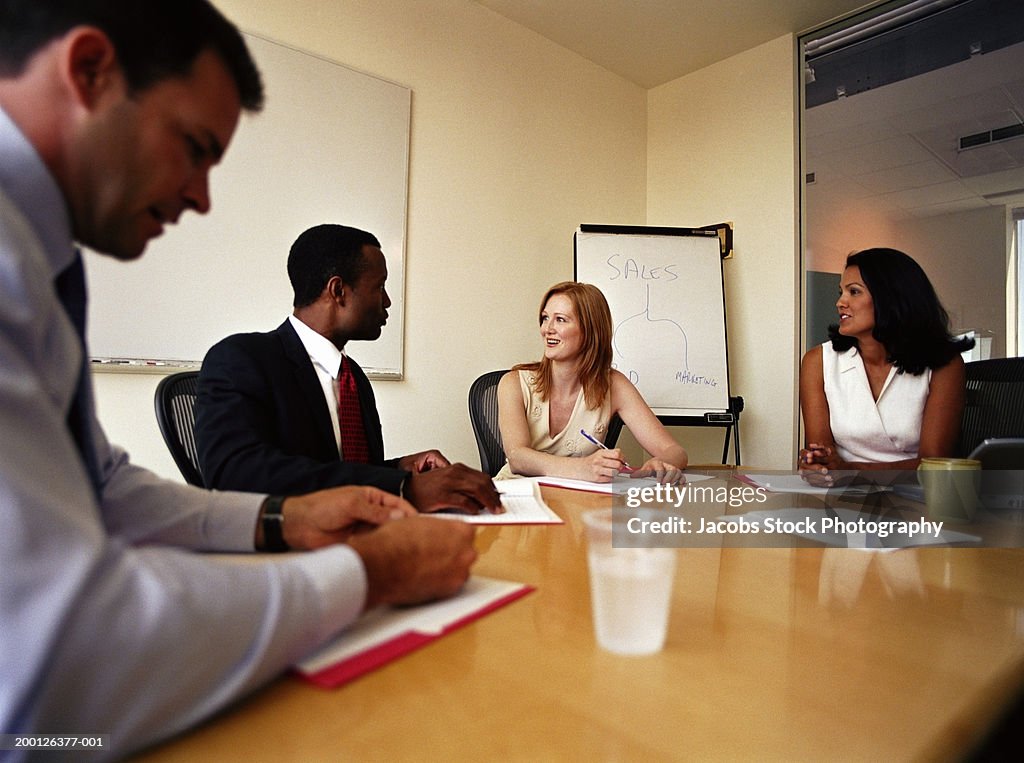 Two businessmen and two businesswomen in meeting room