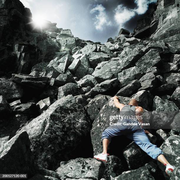 man climbing rocks, rear view (digital composite) - soloing stock pictures, royalty-free photos & images