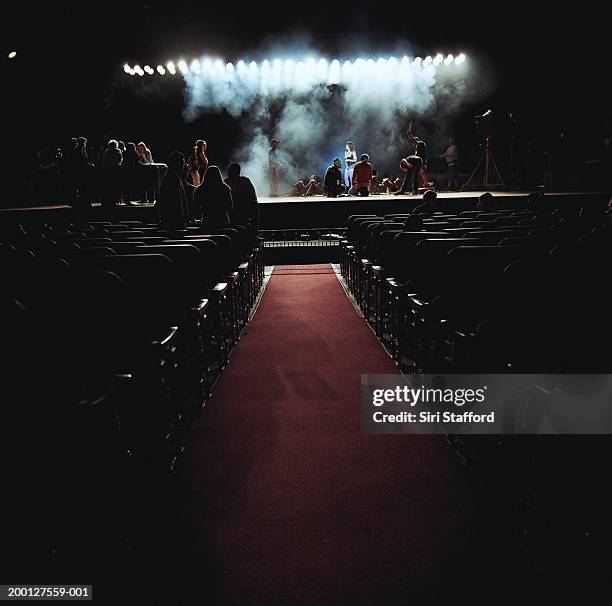 people on stage in empty theater, preparing for event - theater stock-fotos und bilder