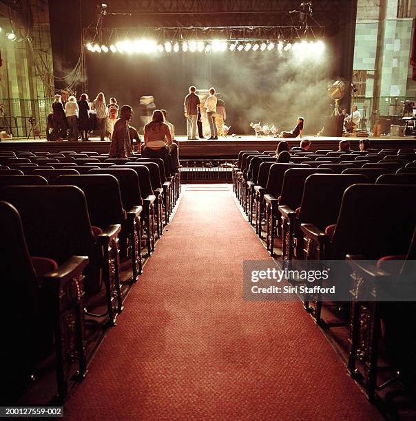 people on stage in empty theatre, waiting for event - rehearsal stock-fotos und bilder