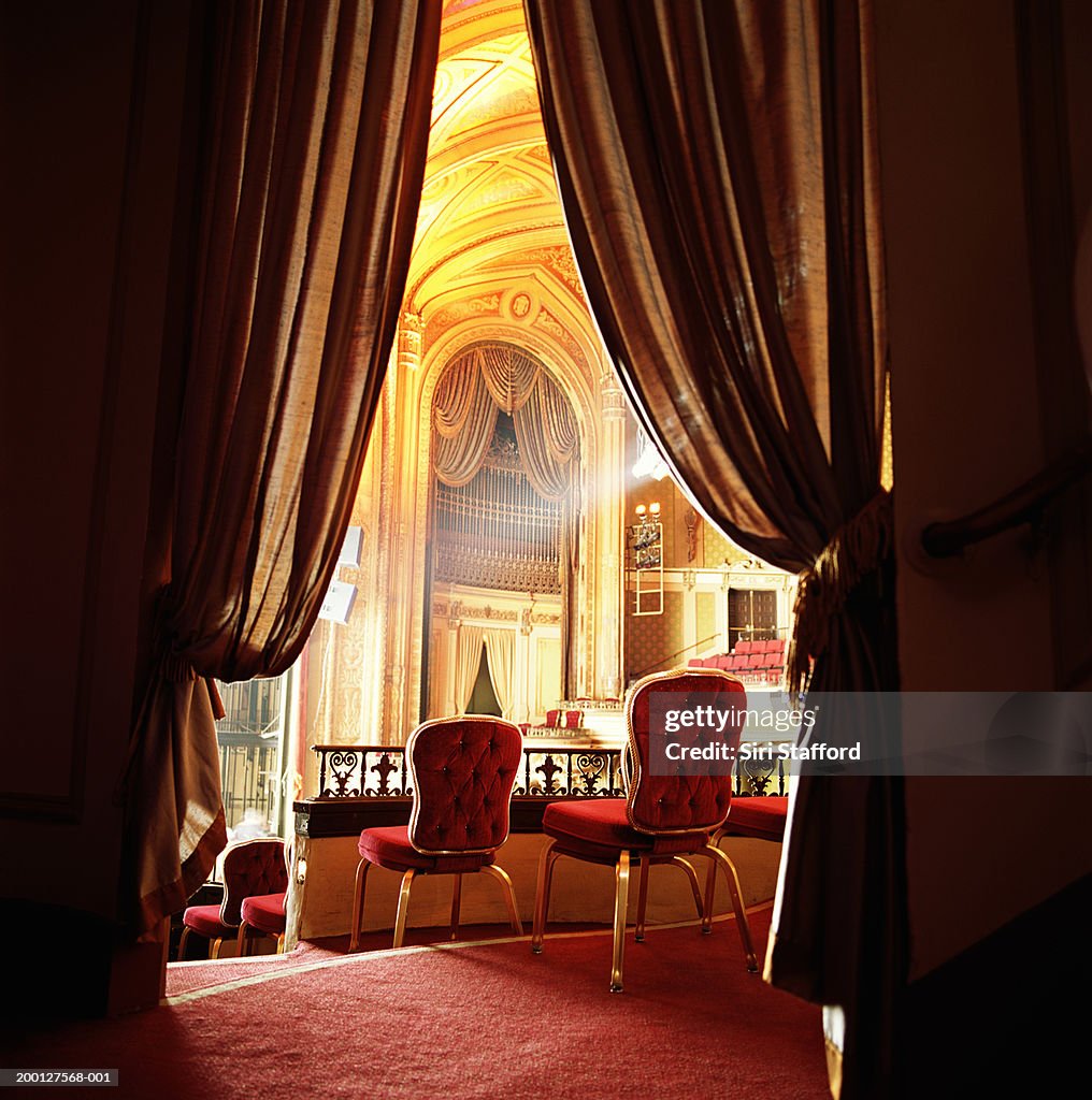 Red balcony seats in theater, rear view