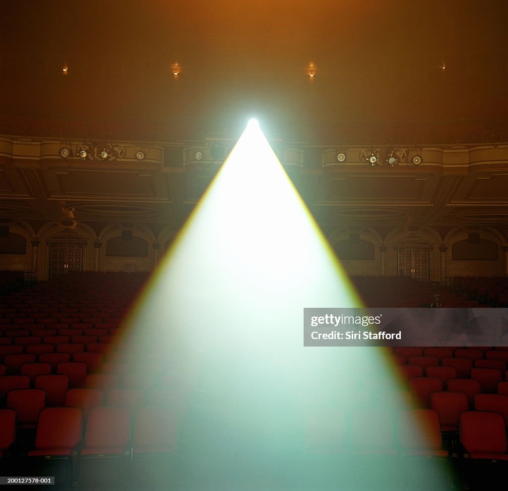 Beam of spotlight projected in theater