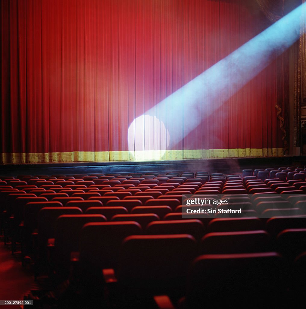 Spotlight on red theater curtain
