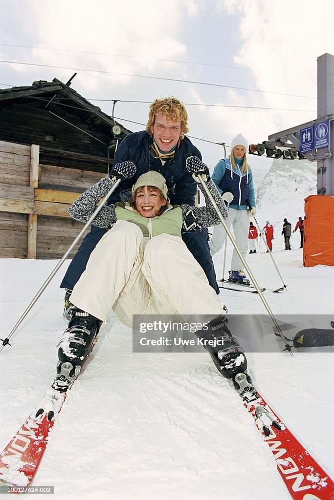 Young couple on ski slope, portrait