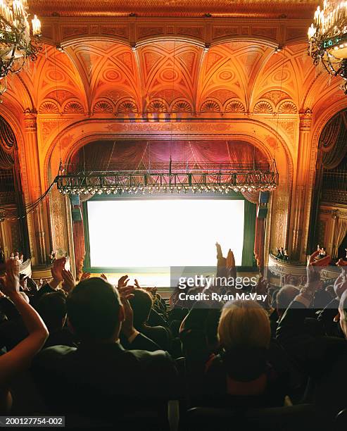 audience applauding in theater, rear view - applauding stock pictures, royalty-free photos & images