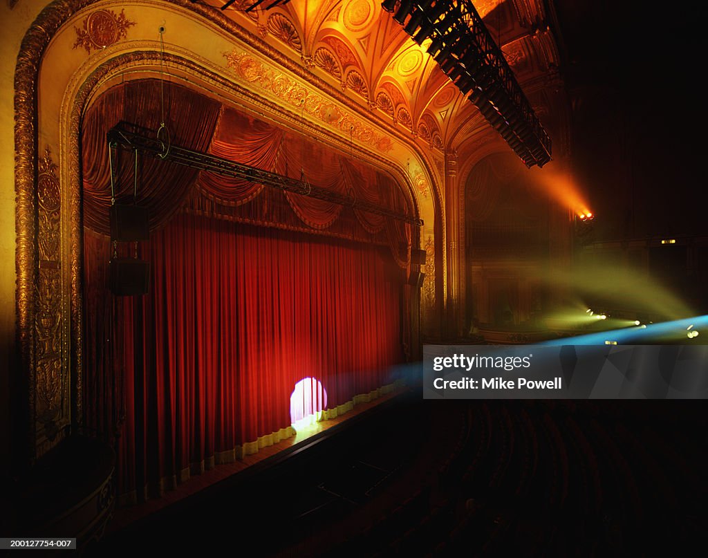 Spotlight shining on curtain of theater