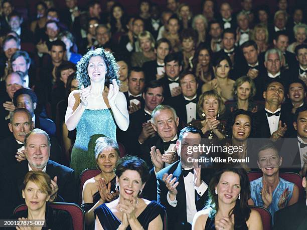 woman standing it theater audience, applauding, portrait - spotlight person stock pictures, royalty-free photos & images