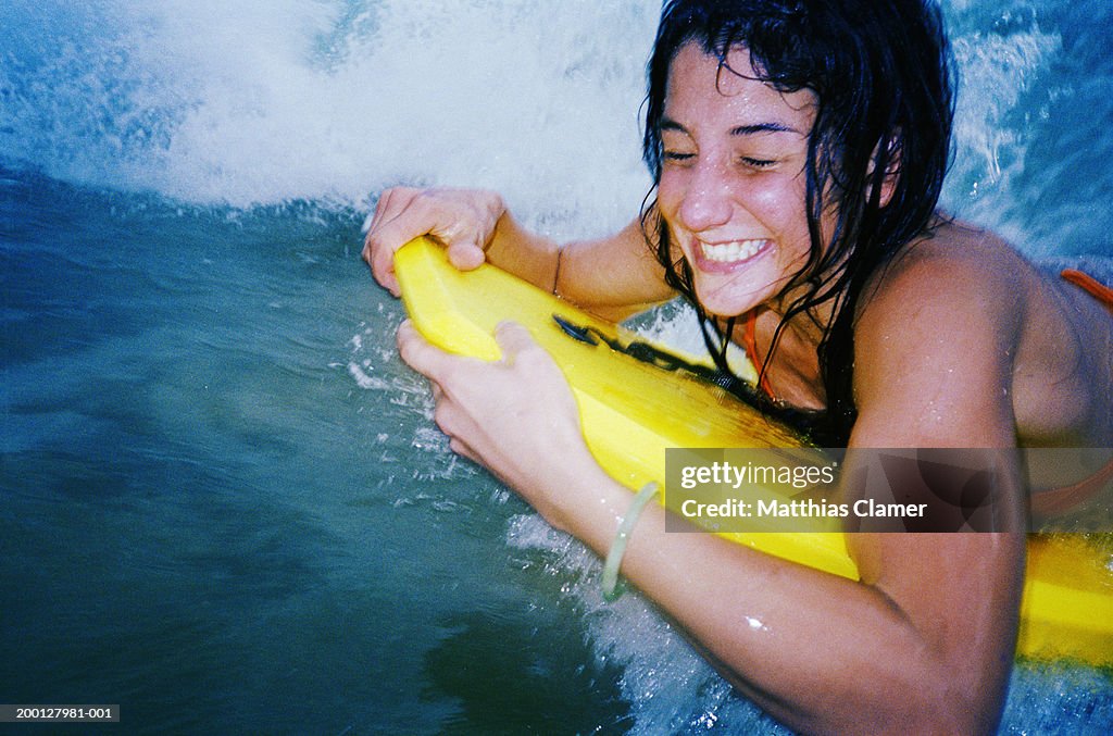 Young woman body surfing, close up
