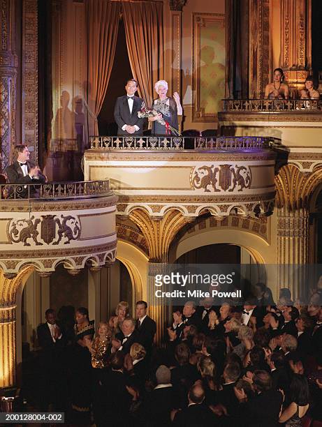 audience applauding couple in balcony - applauding balcony stock pictures, royalty-free photos & images