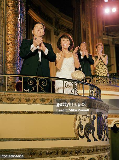 two couples applauding in balcony of theater - spettatore opera foto e immagini stock