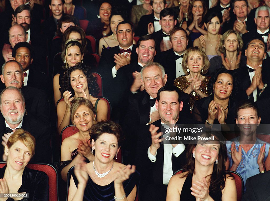 Theater audience in formal attire, applauding, portrait