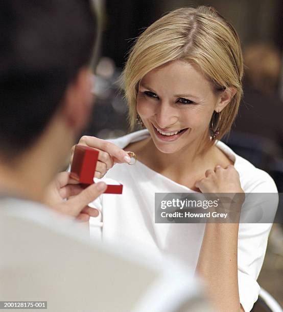 woman taking ring from box held by man (focus on woman) - jewellery gift stock pictures, royalty-free photos & images