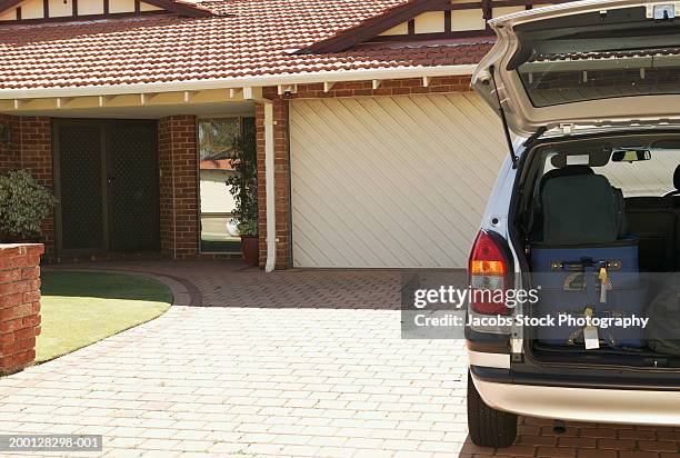 car on driveway, suitcases in open boot - car back door stock pictures, royalty-free photos & images