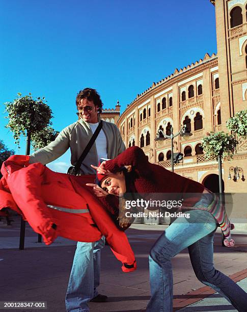 spain, madrid, couple 'bullfighting' outside las ventas bullring - woman horn stock-fotos und bilder