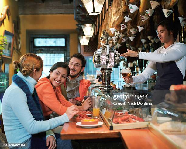 group of friends in tapas bar - madrid food stock pictures, royalty-free photos & images