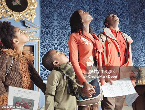 parents and children (5-7) looking at ceiling in museum - children museum stock pictures, royalty-free photos & images