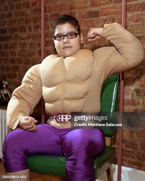 boy (10-12) wearing muscle costume, flexing arms, portrait - stoneplus1 stock pictures, royalty-free photos & images