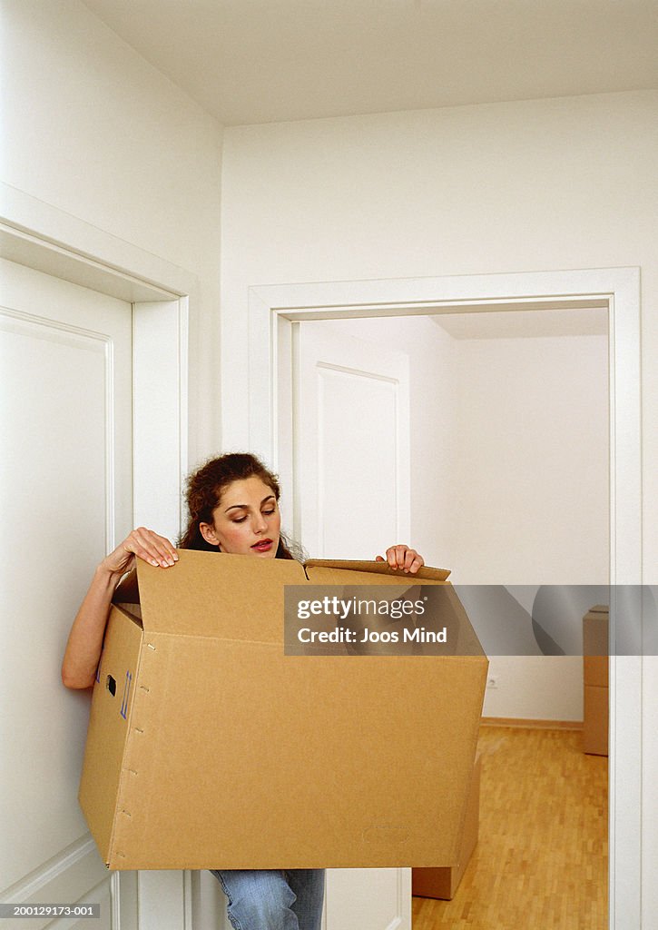 Young woman looking into box