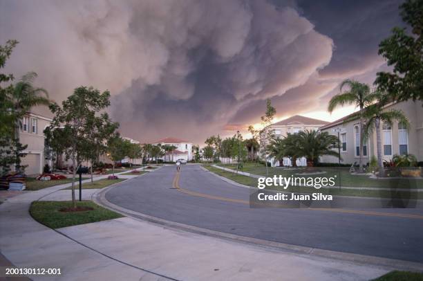 forest fire burning behind community - forest fire house stock pictures, royalty-free photos & images