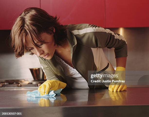 young woman cleaning kitchen counter - rubber gloves stock pictures, royalty-free photos & images