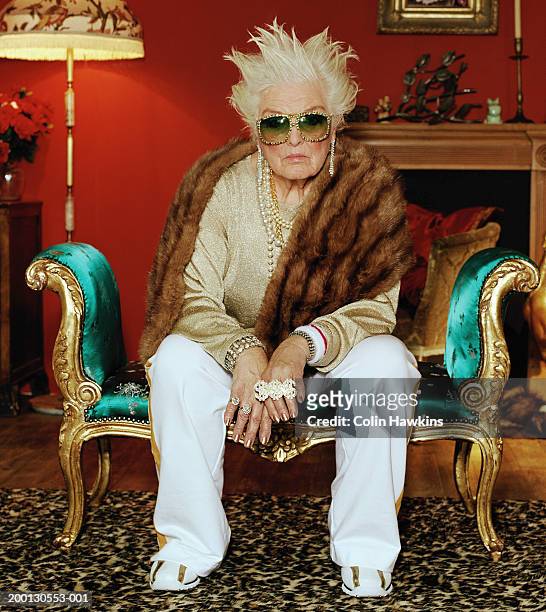 senior woman on chaise longue, wearing hip hop accessories, portrait - animal pattern 個照片及圖片檔