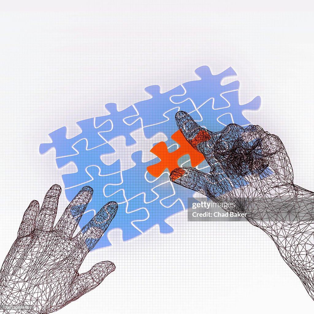 Wire frame hands over puzzle