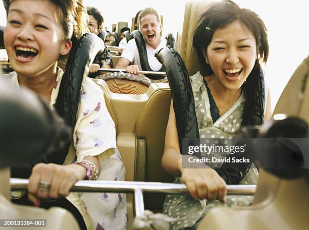people on rollercoaster - young woman screaming on a rollercoaster stock-fotos und bilder
