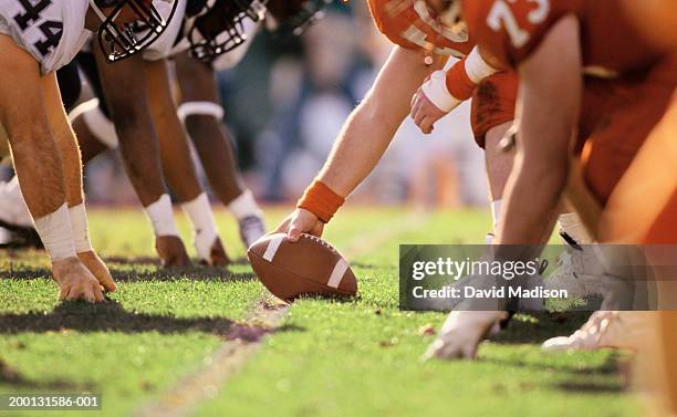 american football game, players at line of scrimmage, close-up - offense sporting position stock-fotos und bilder