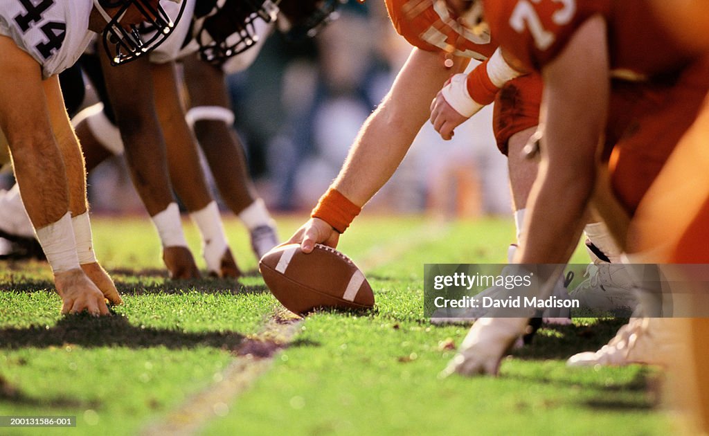 American football game, players at line of scrimmage, close-up