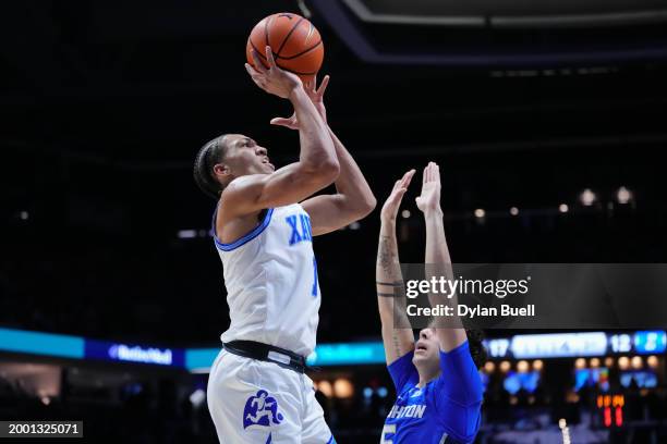 Desmond Claude of the Xavier Musketeers attempts a shot while being guarded by Francisco Farabello of the Creighton Blue Jays in the first half at...