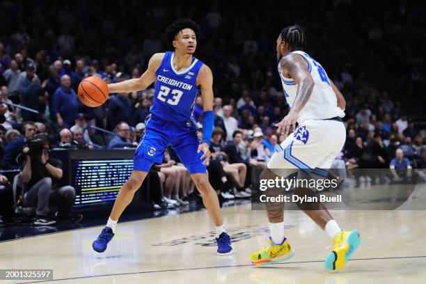 Trey Alexander of the Creighton Blue Jays dribbles the ball while being guarded by Dayvion McKnight of the Xavier Musketeers in the second half at...