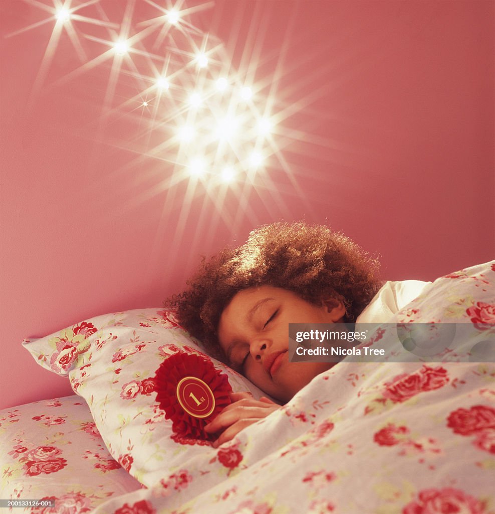 Girl (6-8) asleep, bright lights above bed