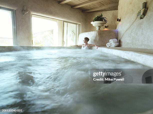 woman relaxing in whirlpool - centro benessere stabilimento termale foto e immagini stock