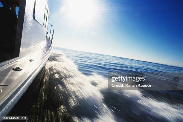 water churning at side of speeding boat (blurred motion) - boat wake stock pictures, royalty-free photos & images