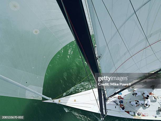 crew working on deck of sailing ocean going racing yacht - squadra di vela foto e immagini stock
